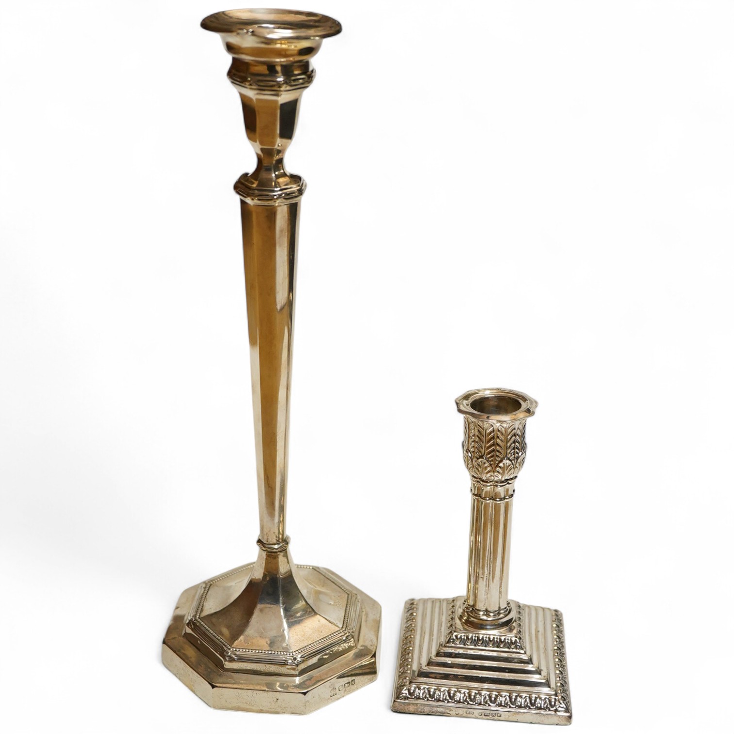 A George V silver candlestick, Sheffield, 1933, James Deakin & Sons, weight base together with a Victorian dwarf cluster column candlestick on stepped weighted base, (2)